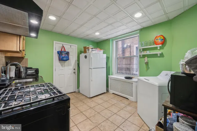 a kitchen with a stove cabinets and a refrigerator
