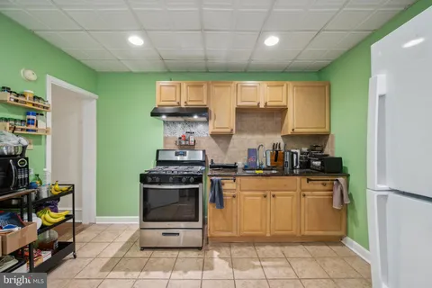 a spacious bedroom with a bed and a flat tv screen on wall