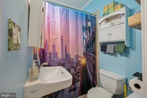 a view of a brick house with a small yard and wooden fence