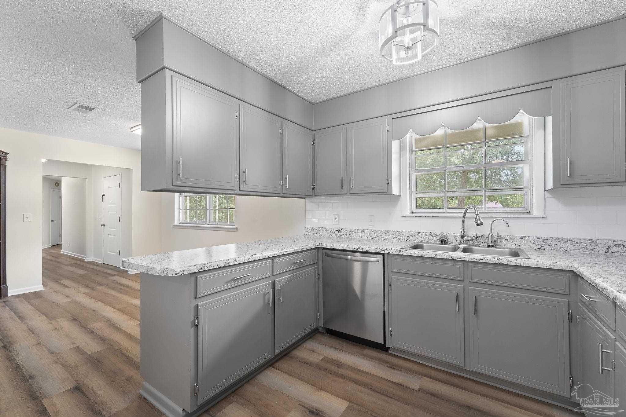 6472 Sandy Lane Milton, FL 32570 - Photo 15 of 51 a kitchen with a sink window and cabinets