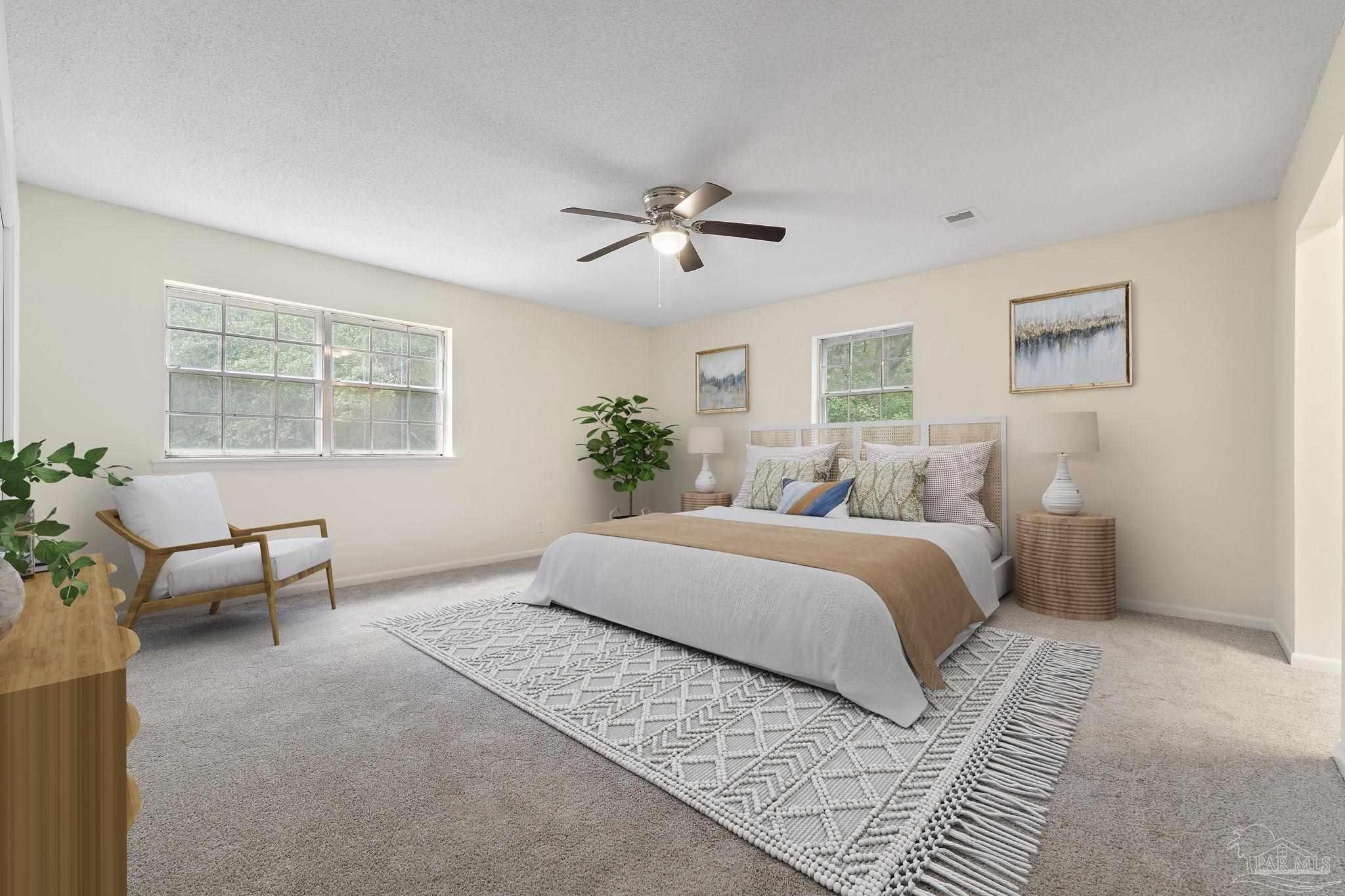 6472 Sandy Lane Milton, FL 32570 - Photo 19 of 51 a spacious bedroom with a large bed and a chandelier