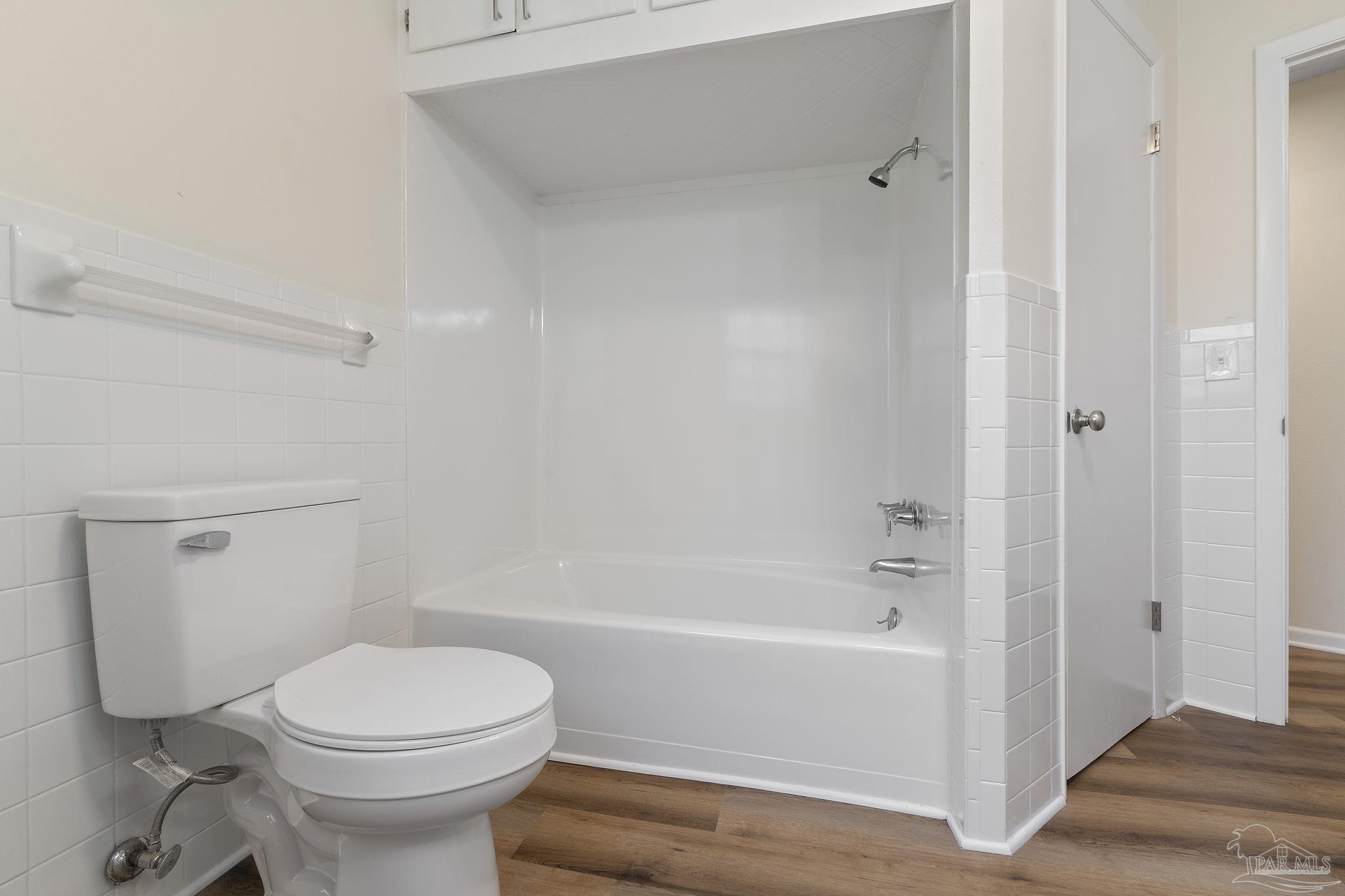 6472 Sandy Lane Milton, FL 32570 - Photo 27 of 51 a bathroom with a toilet and a bath tub