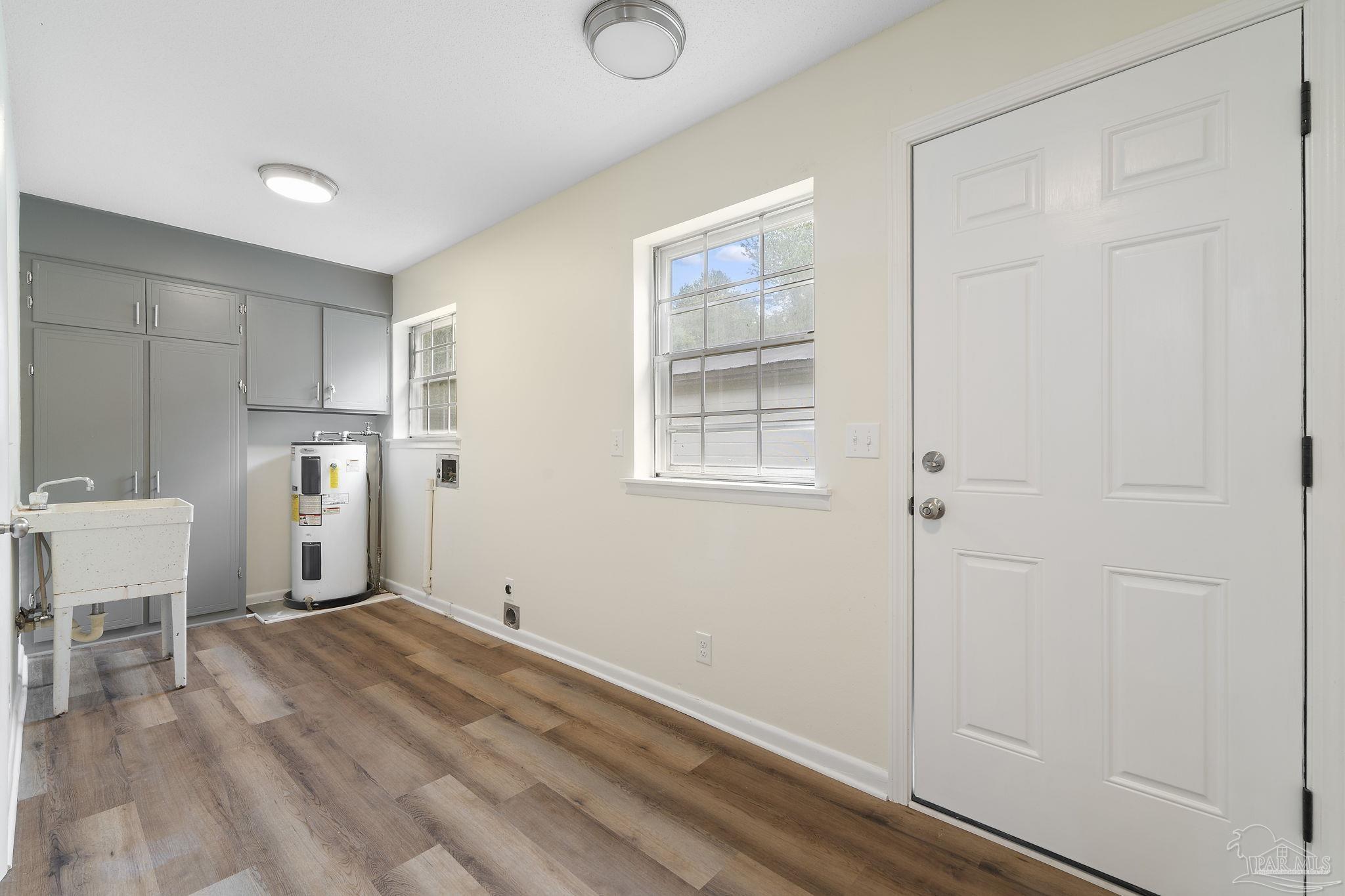 6472 Sandy Lane Milton, FL 32570 - Photo 30 of 51 a view of a kitchen with wooden floor and a window