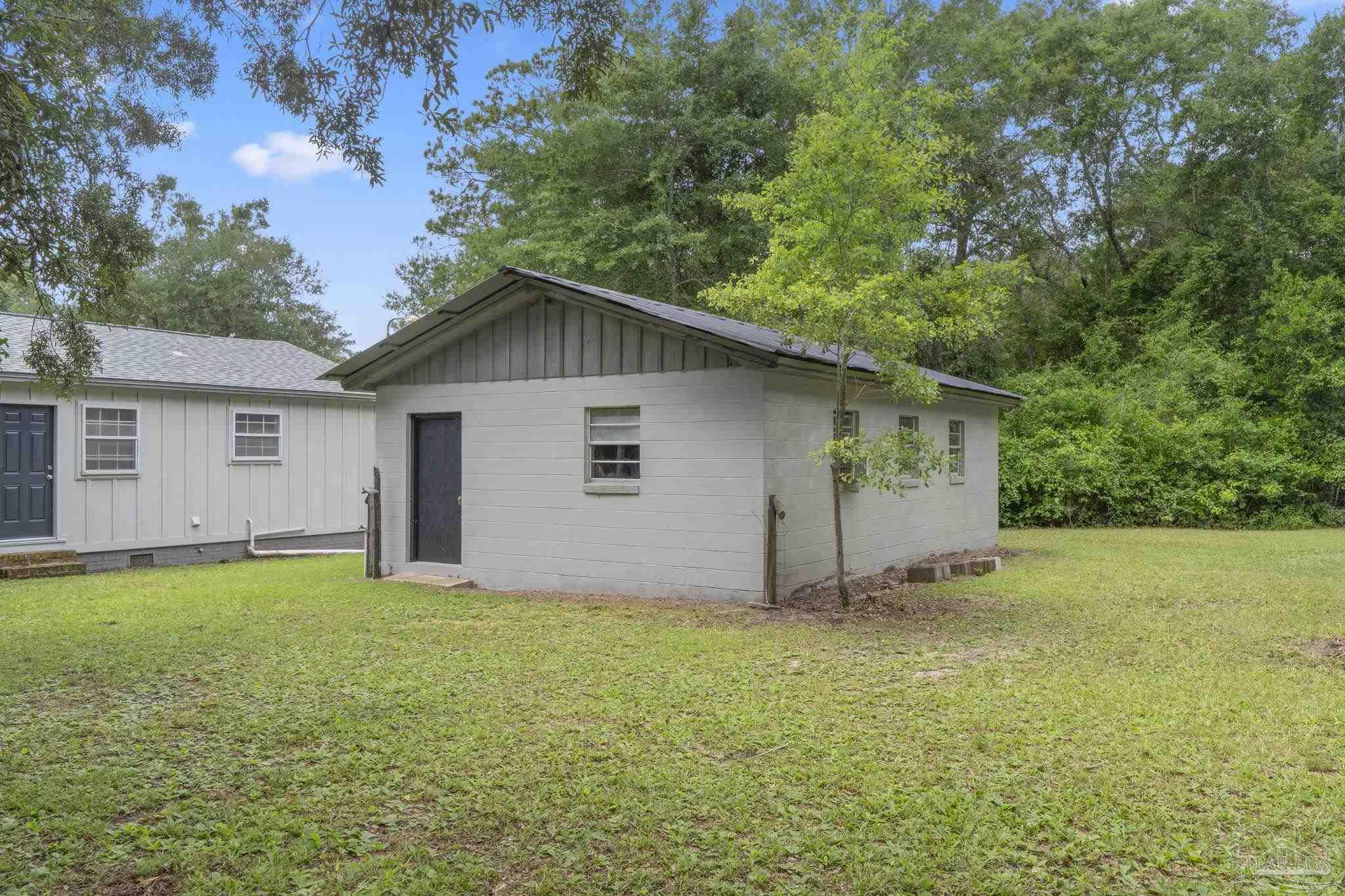 6472 Sandy Lane Milton, FL 32570 - Photo 38 of 51 a view of a house with a yard