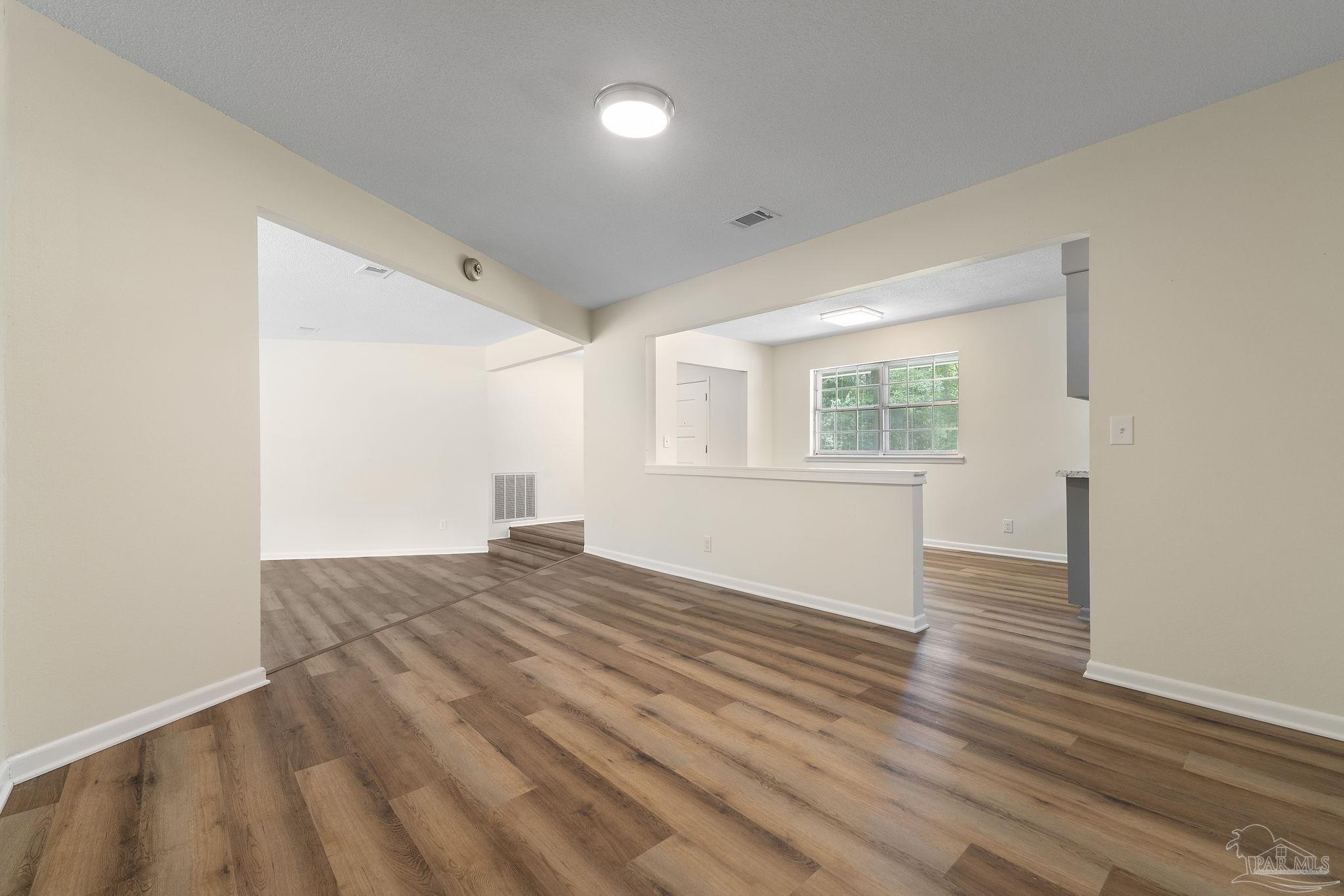 6472 Sandy Lane Milton, FL 32570 - Photo 9 of 51 a view of empty room with wooden floor and fan