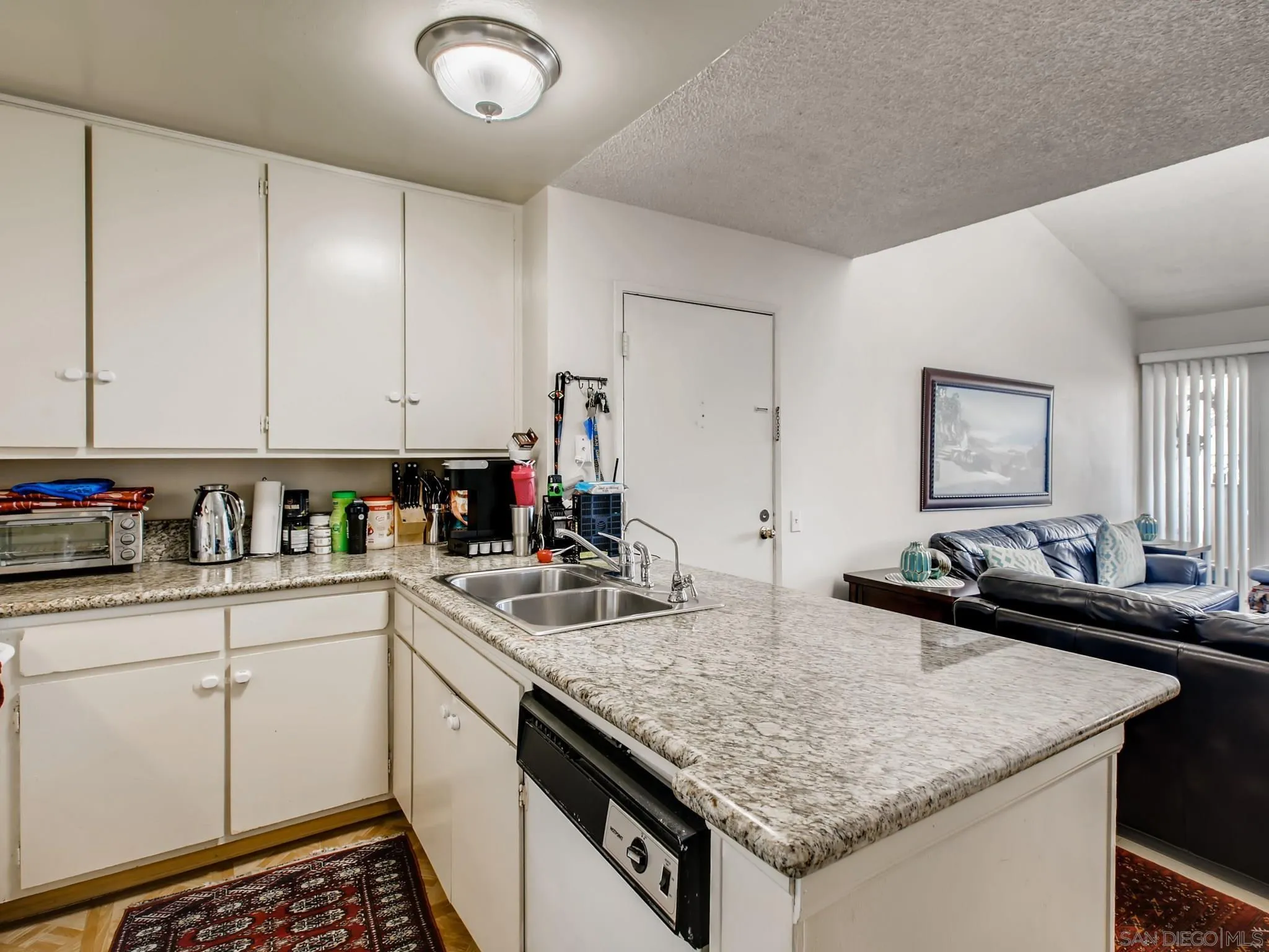 3550 Ruffin Road, Unit 239 San Diego, CA 92123 - Photo 11 of 27 a kitchen with a sink and cabinets