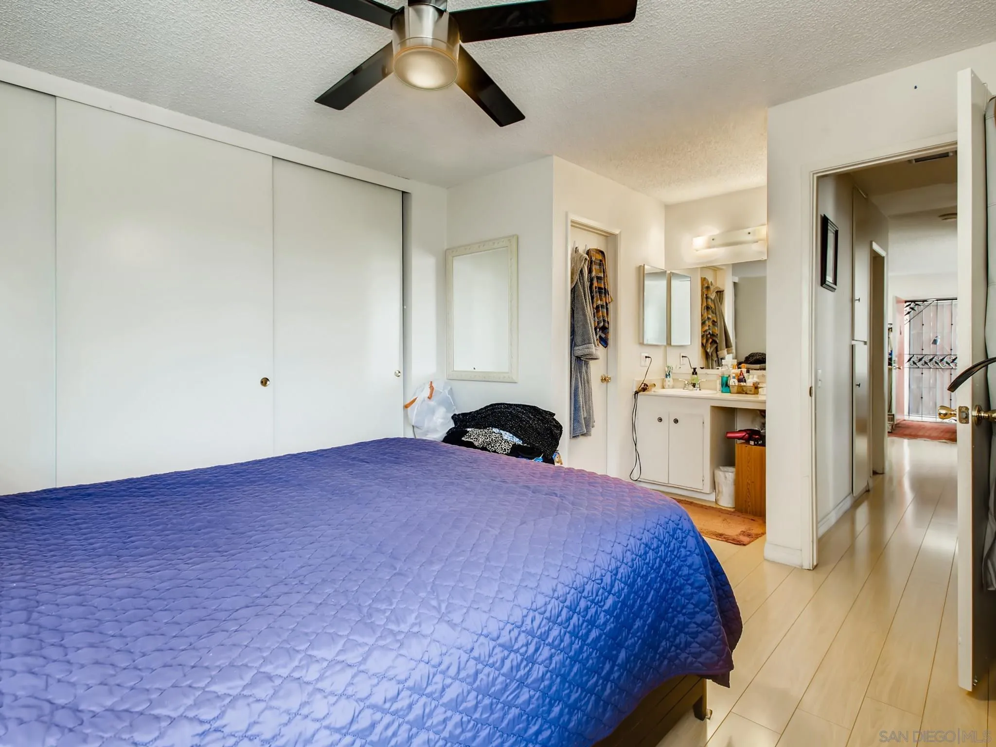 3550 Ruffin Road, Unit 239 San Diego, CA 92123 - Photo 14 of 27 a bedroom with a large bed and a view of kitchen