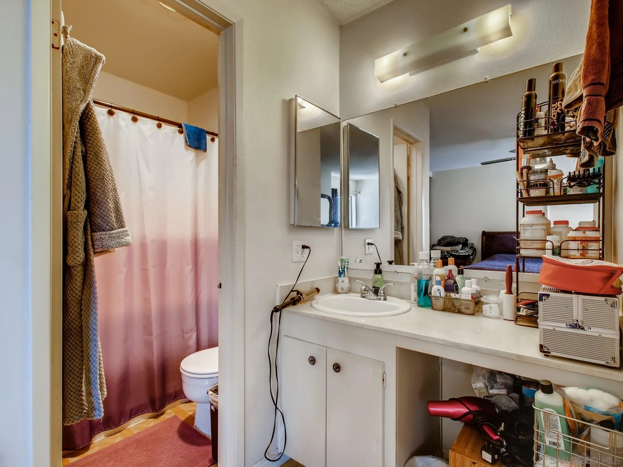 3550 Ruffin Road, Unit 239 San Diego, CA 92123 - Photo 17 of 27 a bathroom with a sink vanity mirror and toilet