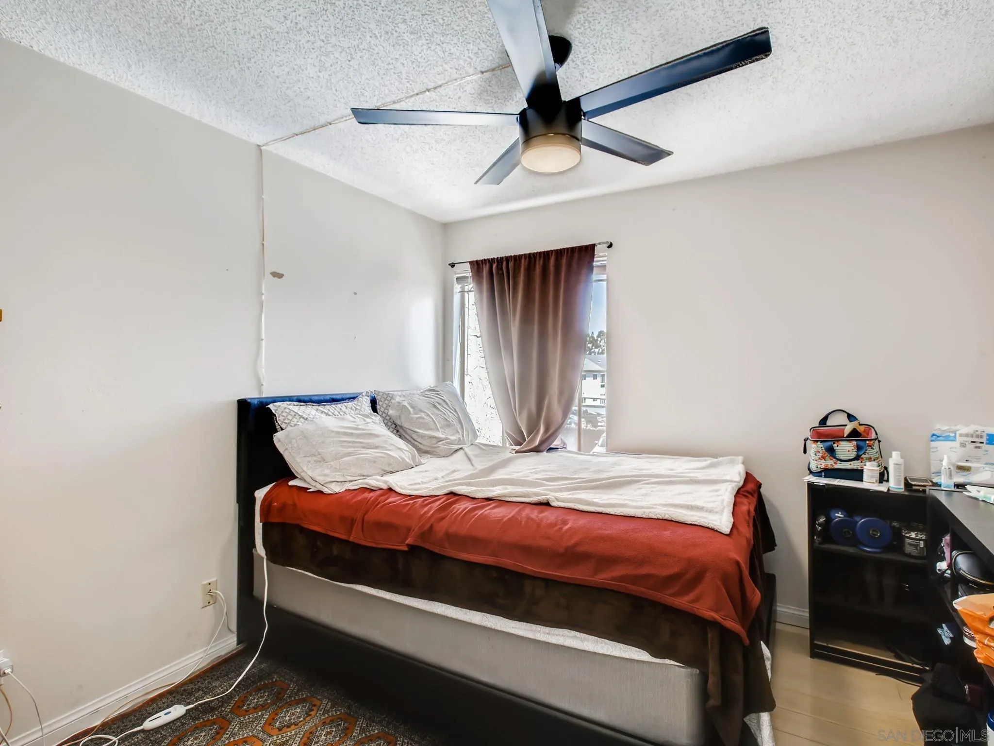 3550 Ruffin Road, Unit 239 San Diego, CA 92123 - Photo 20 of 27 a bedroom with a bed and a chandelier