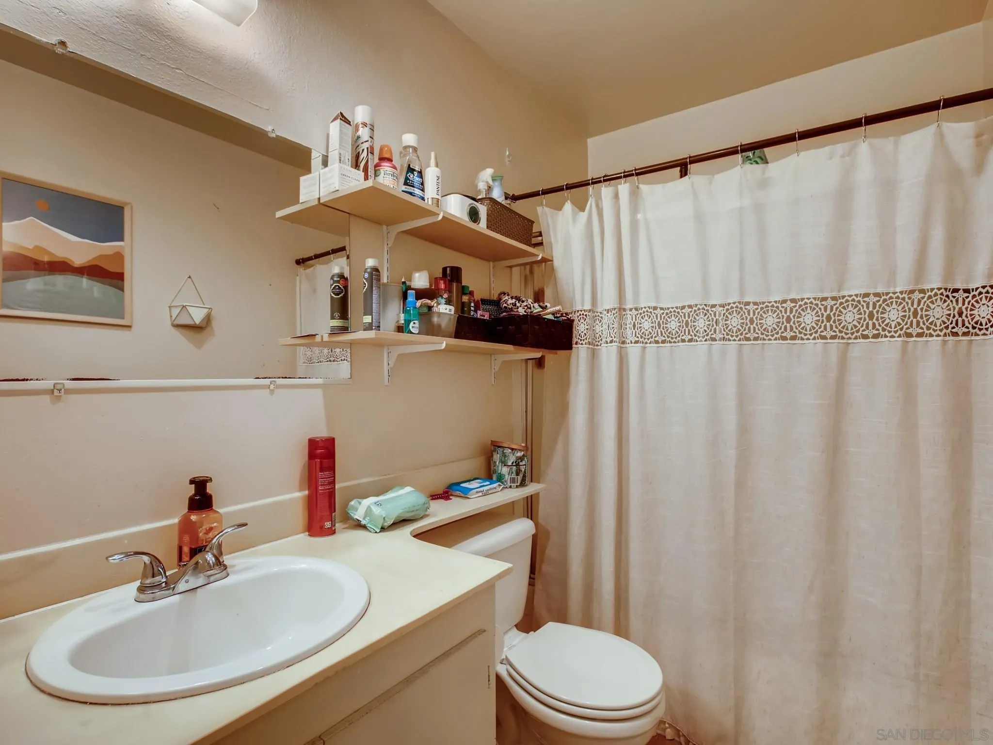 3550 Ruffin Road, Unit 239 San Diego, CA 92123 - Photo 21 of 27 a bathroom with a sink a toilet and a mirror