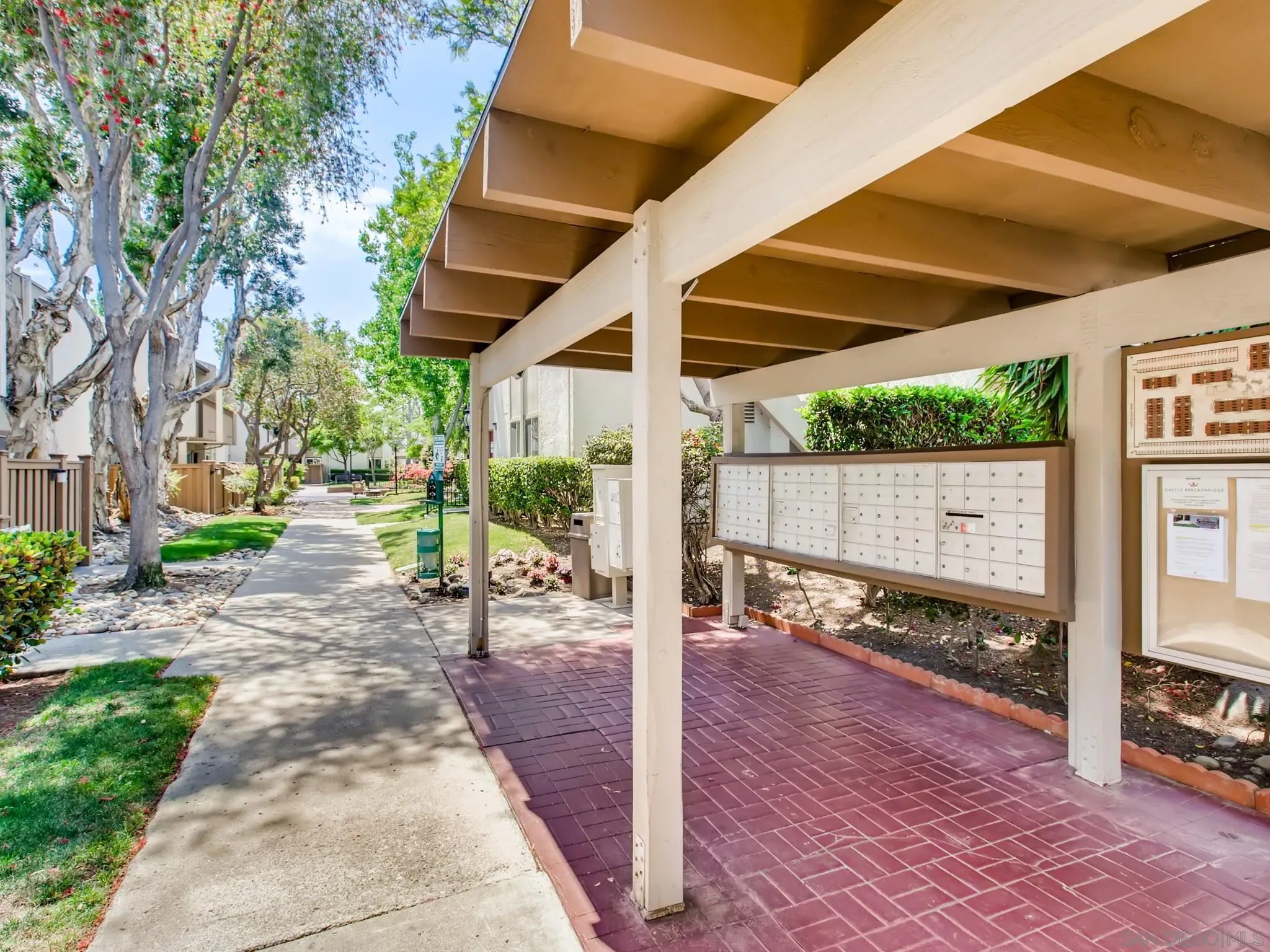 3550 Ruffin Road, Unit 239 San Diego, CA 92123 - Photo 26 of 27 a view of a patio with table and chairs potted plants and floor to ceiling window