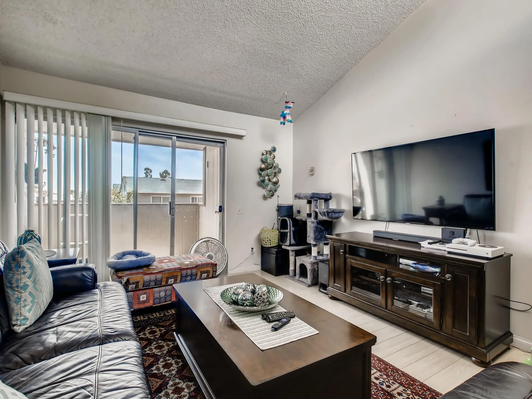 3550 Ruffin Road, Unit 239 San Diego, CA 92123 - Photo 7 of 27 a living room with furniture and a flat screen tv