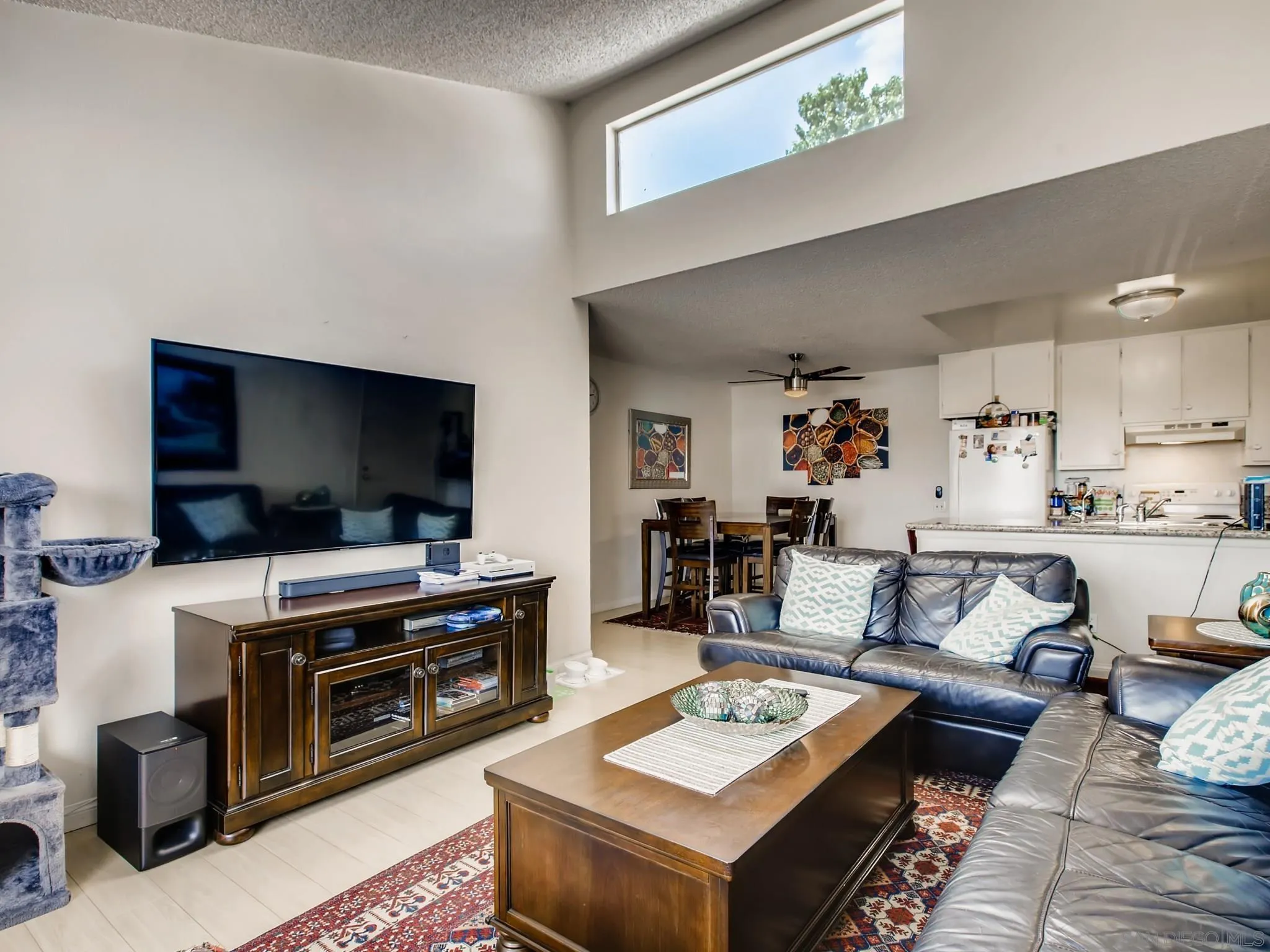 3550 Ruffin Road, Unit 239 San Diego, CA 92123 - Photo 8 of 27 a living room with furniture and a flat screen tv