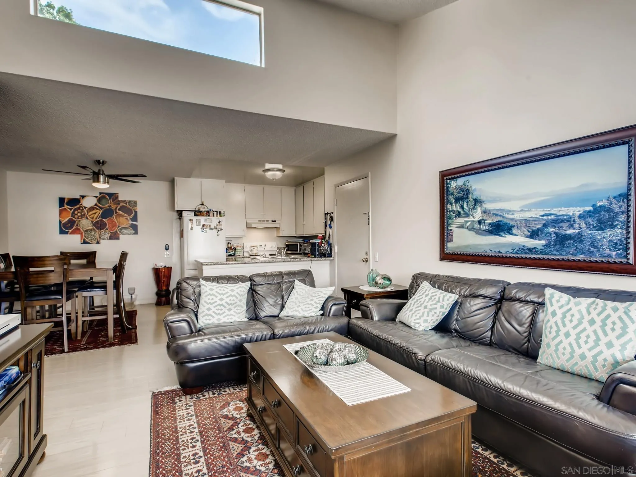 3550 Ruffin Road, Unit 239 San Diego, CA 92123 - Photo 9 of 27 a living room with furniture and a dining table with rug