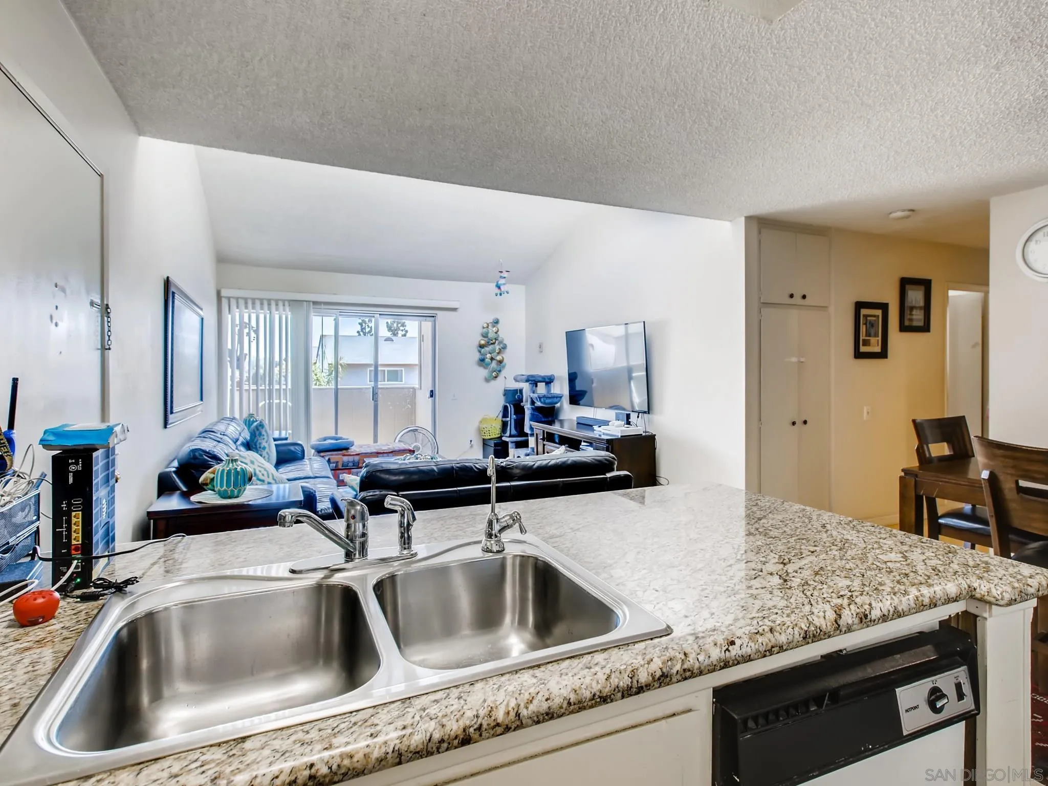 3550 Ruffin Road, Unit 239 San Diego, CA 92123 - Photo 10 of 27 a kitchen with sink a faucet a counter and chairs