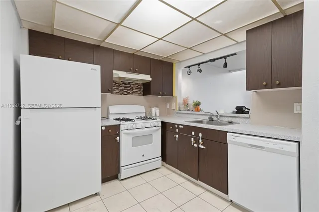 a kitchen with stainless steel appliances granite countertop a refrigerator stove a sink and dishwasher