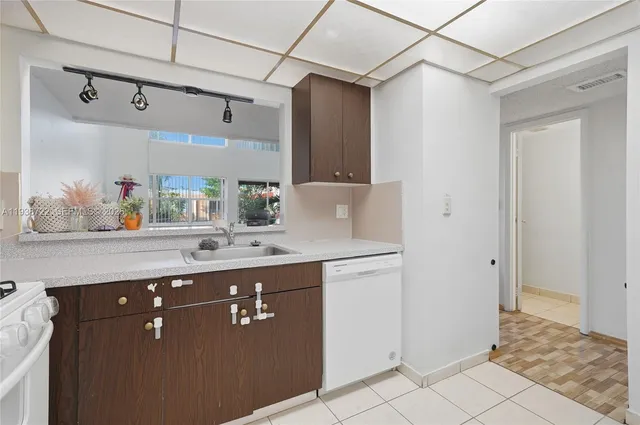 a bathroom with a sink a mirror and a shower