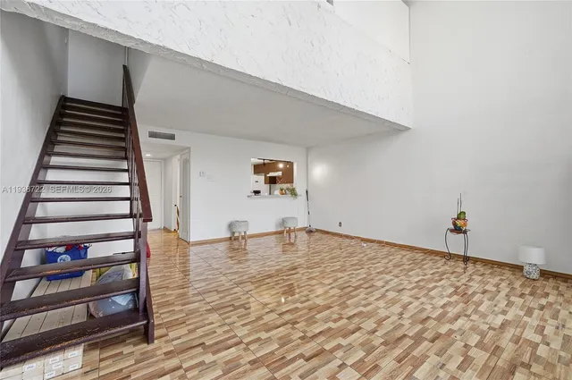 a view of a room with wooden floor and stairs