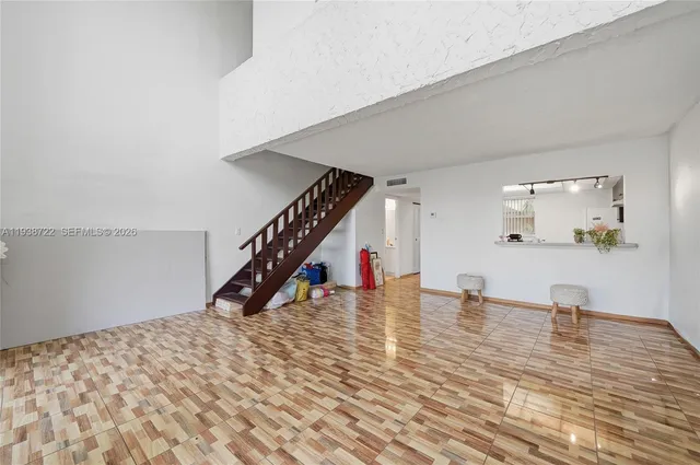 a view of empty room with wooden floor