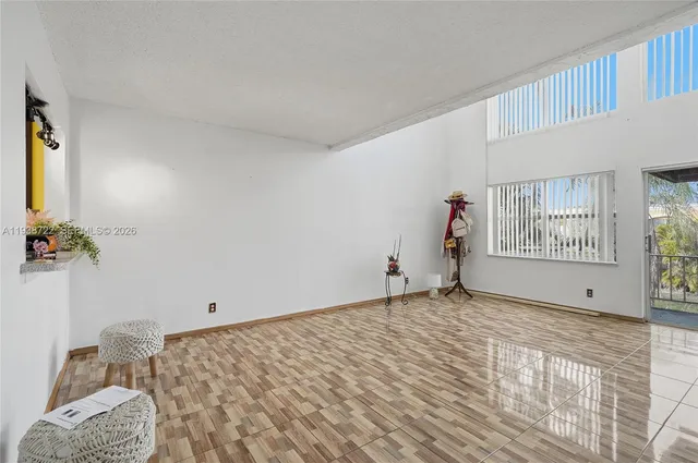 a view of empty room with window and ceiling fan