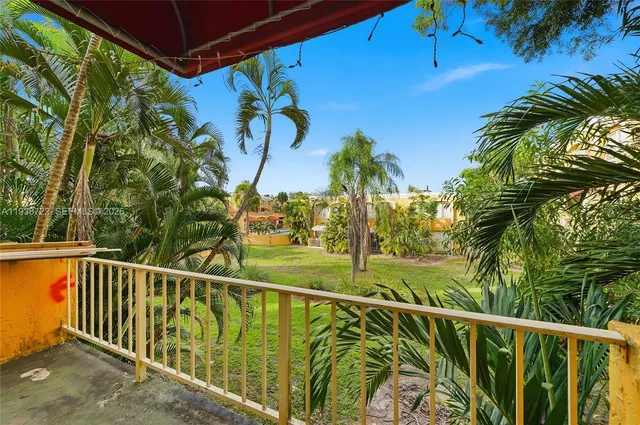 a view of a yard with potted plants