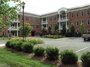 a front view of a house with a yard and outdoor seating