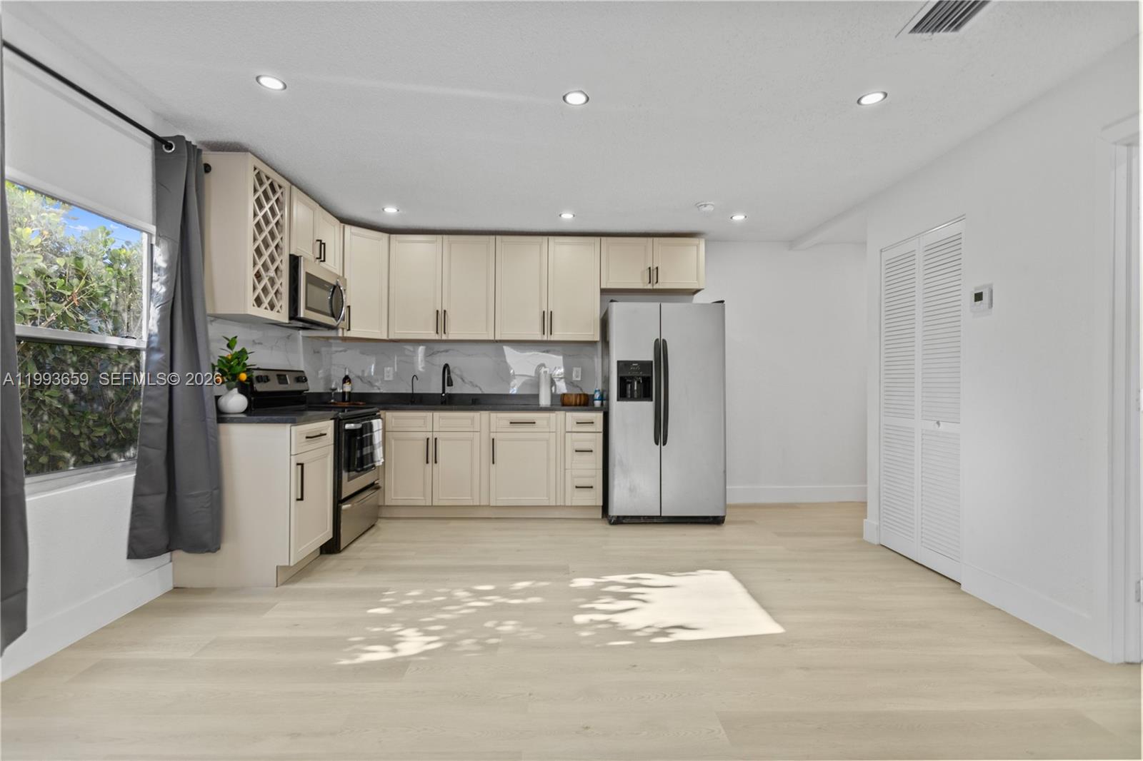 171 West 13th Street Hialeah, FL 33010 - Photo 12 of 84 a kitchen with refrigerator and cabinets