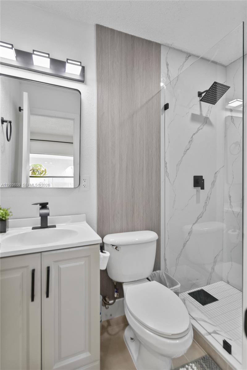 171 West 13th Street Hialeah, FL 33010 - Photo 21 of 84 a white toilet sitting next to a bathroom sink