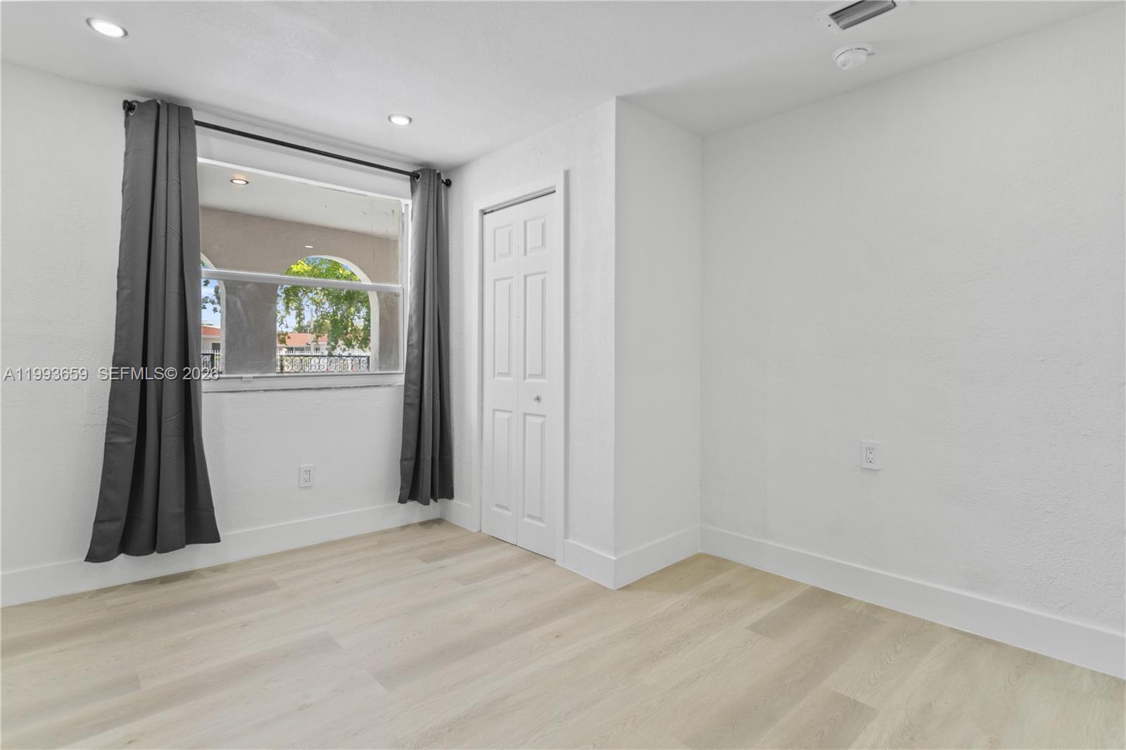171 West 13th Street Hialeah, FL 33010 - Photo 37 of 84 an empty room with a fireplace and a window