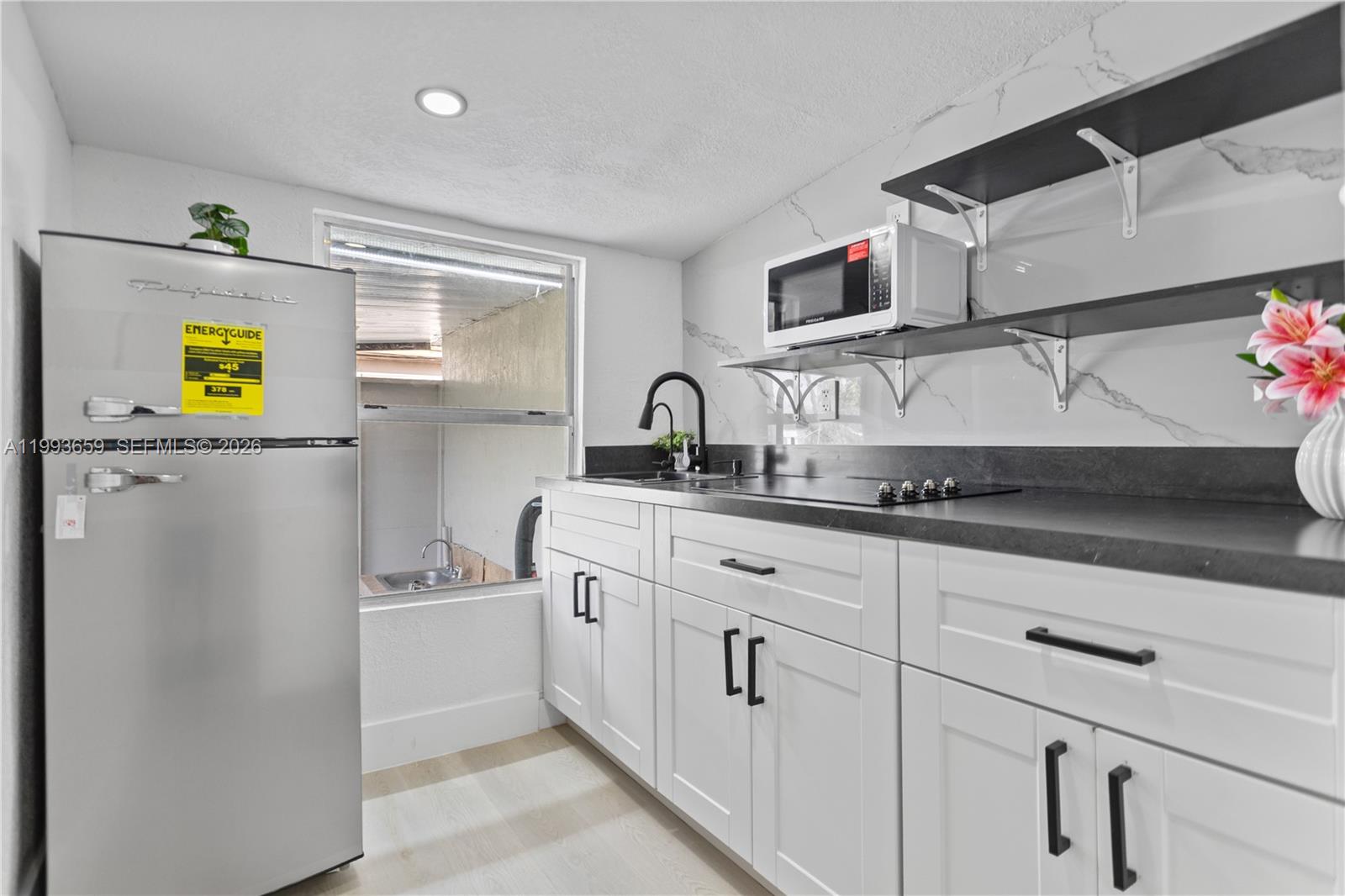 171 West 13th Street Hialeah, FL 33010 - Photo 49 of 84 a kitchen with stainless steel appliances a sink and a refrigerator