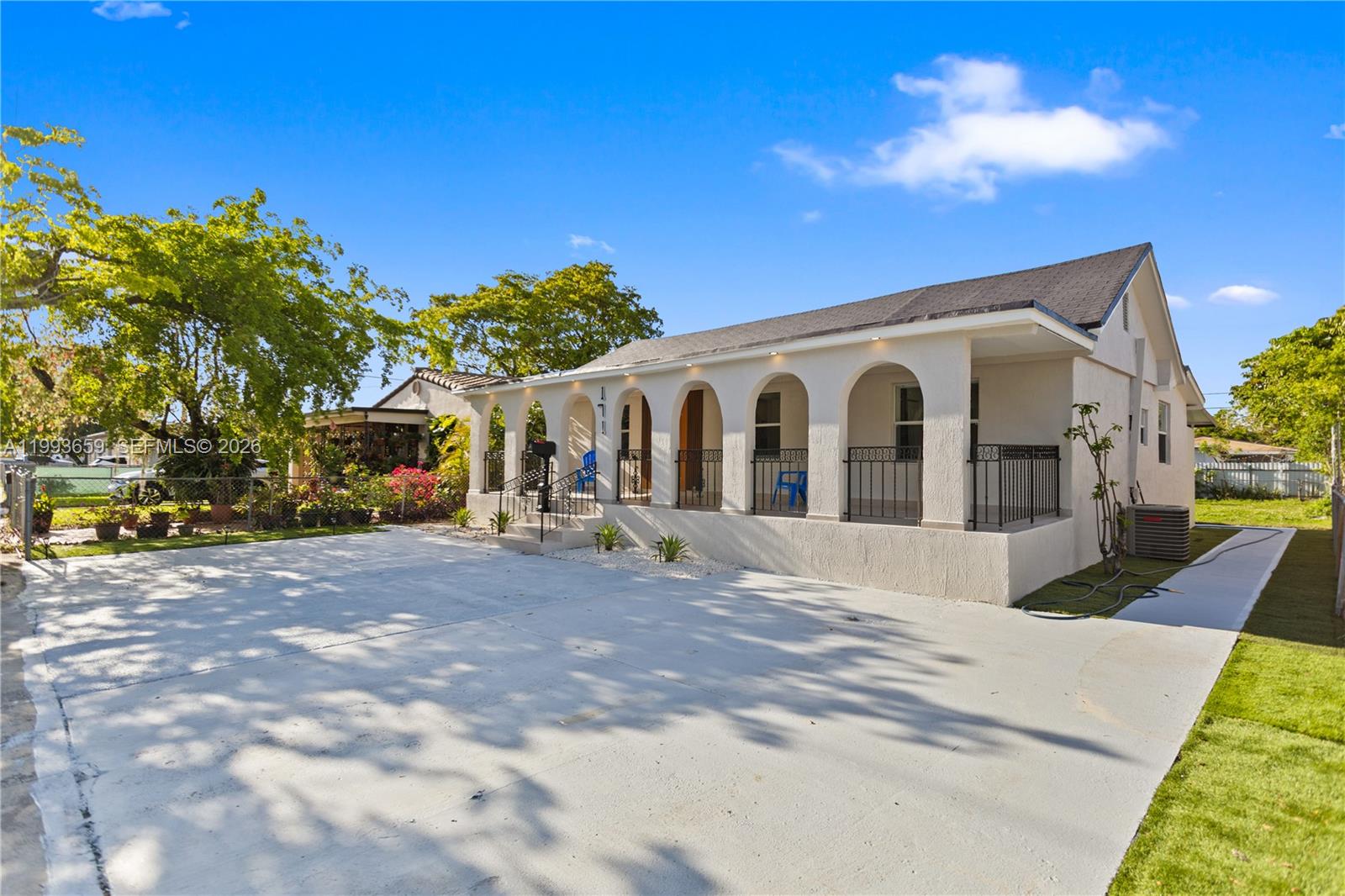 171 West 13th Street Hialeah, FL 33010 - Photo 5 of 84 a view of a white house with a yard