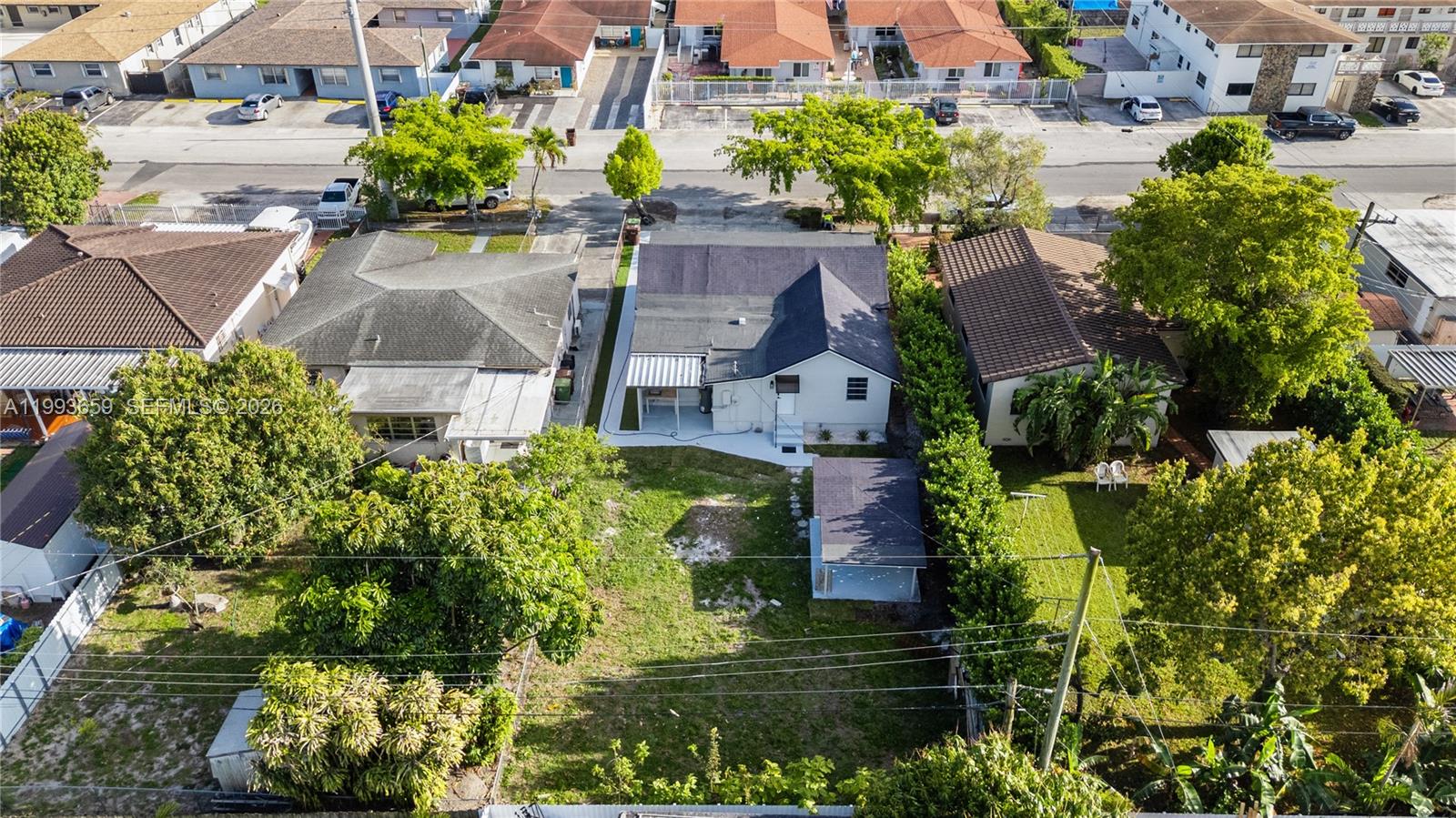 171 West 13th Street Hialeah, FL 33010 - Photo 80 of 84 a aerial view of a house with a yard potted plants and large tree