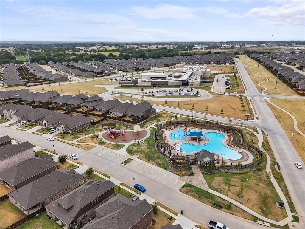 9805 Quail Pointe Road Aubrey, TX 76227 - Photo 30 of 38 Community amenities featuring a swimming pool, playground, and paved walking paths