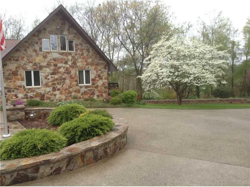 415 Ridge Road Brownsville, PA 15417 - Photo 2 of 22 Exterior Front. Spring has arrived and all the flora is in bloom. The owners have added so much to enhance the outdoor beauty including the aggregate govenors drive and center courtyard.
