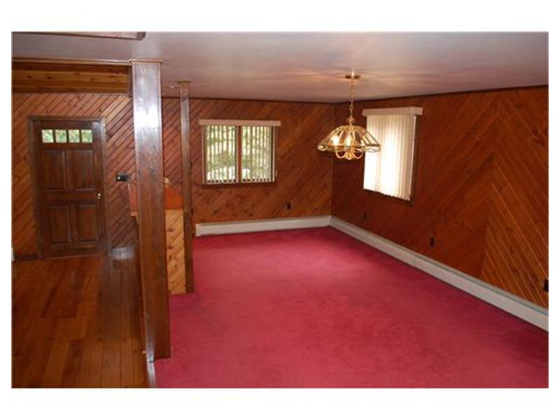415 Ridge Road Brownsville, PA 15417 - Photo 6 of 22 Dining Room. This view shows the front entry with hardwood floors and the enormous dining room, just off the kitchen. This home has an open floor plan and allows one to customize the space to one s needs.