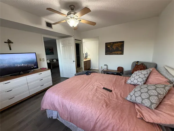 a bedroom with a bed and a flat screen tv