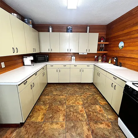 a kitchen with a refrigerator and a stove