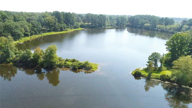 an aerial view of a house with a lake view