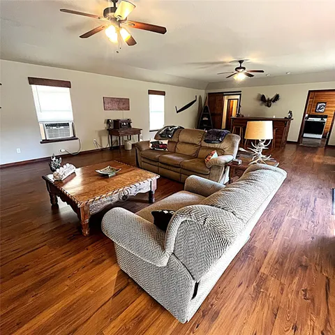 a bedroom with furniture and wooden floor