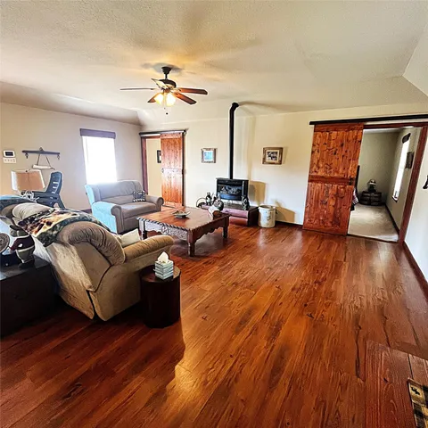 a living room with dining room and wooden floor