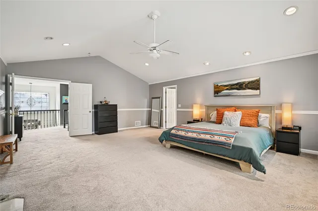 a spacious bedroom with a bed and cabinet