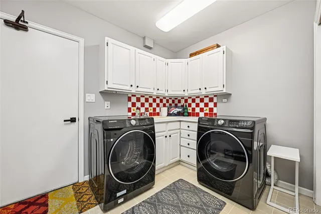 a utility room with sink dryer and washer