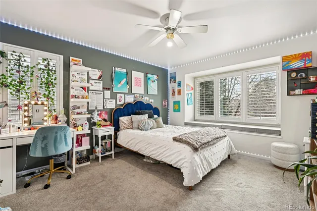 a spacious bedroom with a bed and a large window