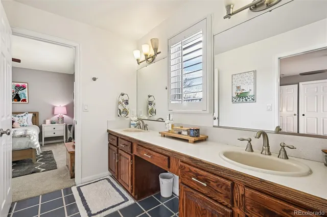a bathroom with double vanity sinks a mirror and a shower