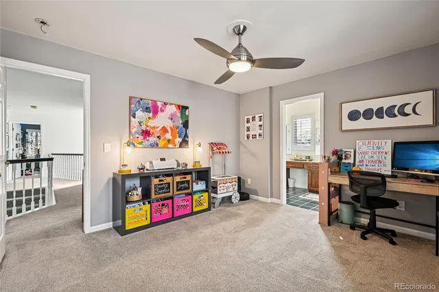 a view of a workspace with furniture and a flat screen tv