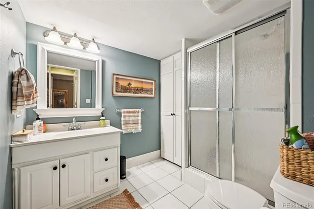 a bathroom with a shower sink and mirror