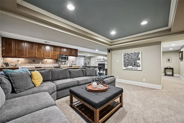 a living room with furniture and kitchen view