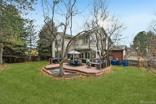 a view of a house with backyard and sitting area