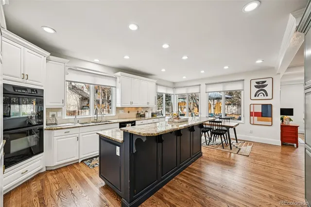 a kitchen with lots of wooden cabinets a sink and appliances