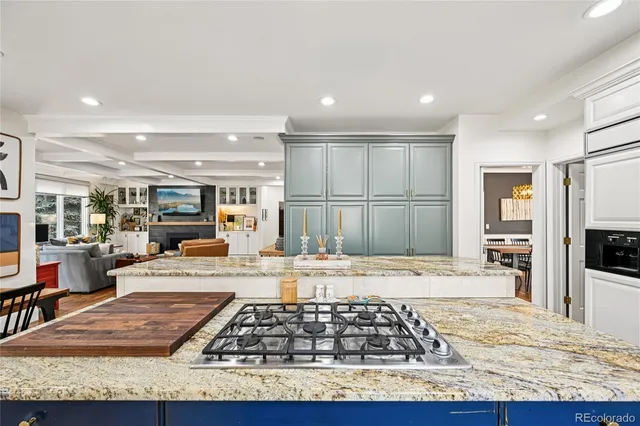 a kitchen with stainless steel appliances granite countertop a stove top oven and a refrigerator